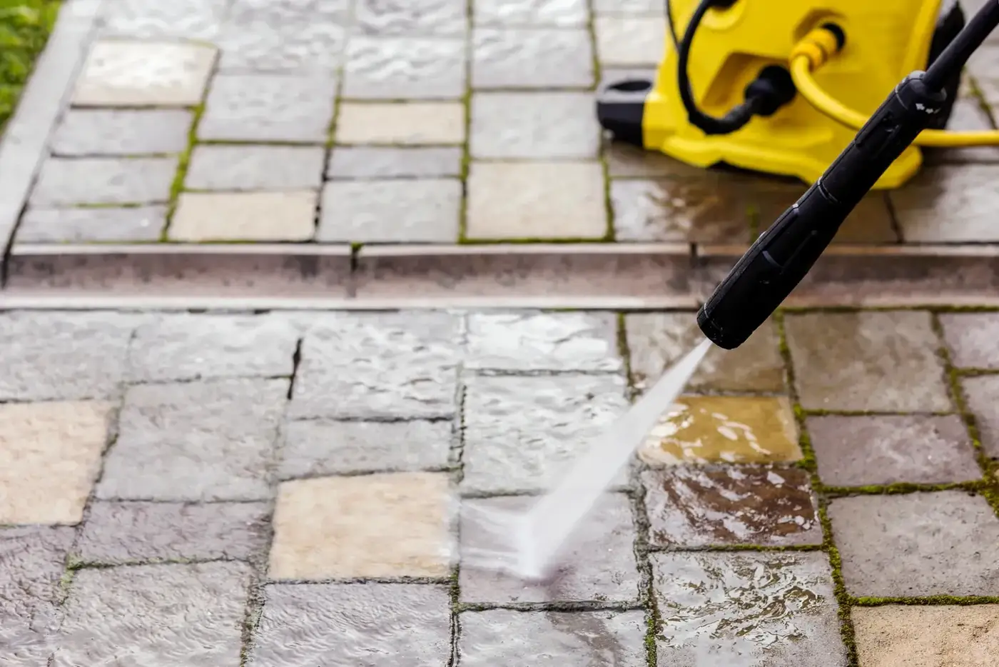 Patio cleaning service pressure washing an outdoor paver surface