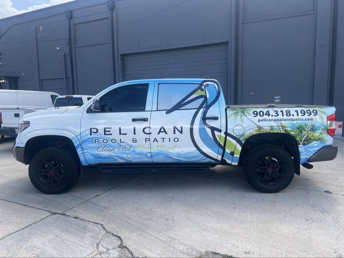 Side view of the Pelican Pool and Patio pool cleaning service truck