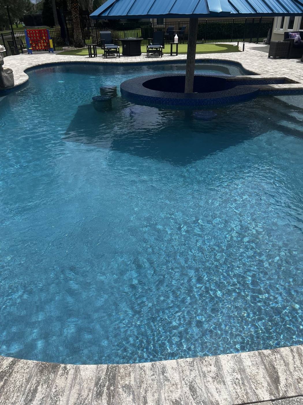 Finished resort-style pool with clear water and swim-up bar