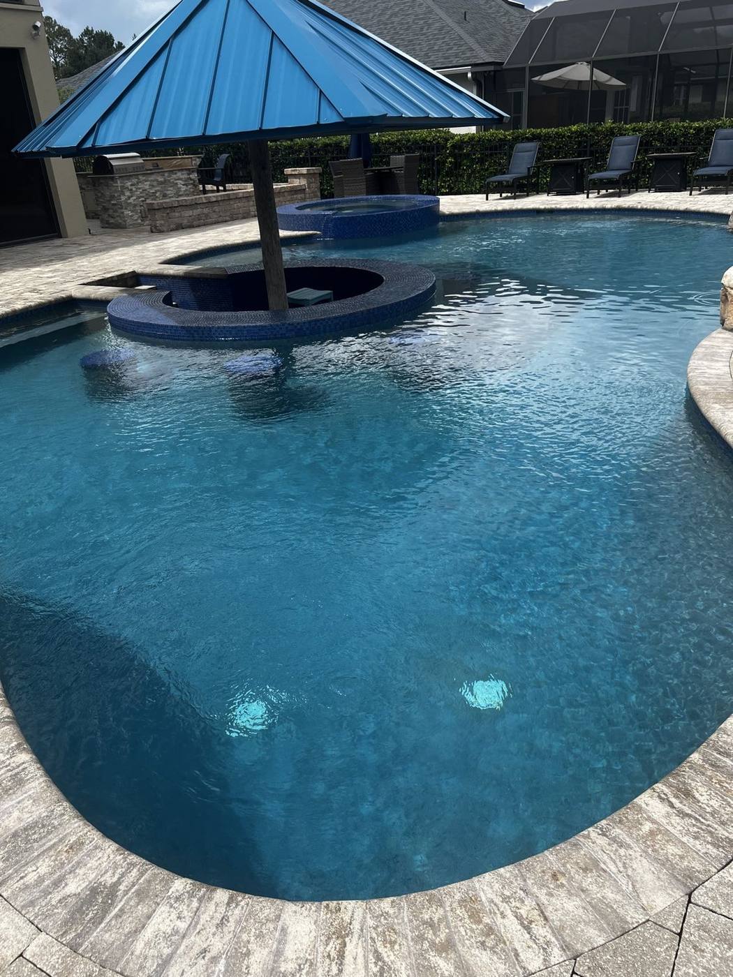 Finished resort-style swimming pool with clear blue water
