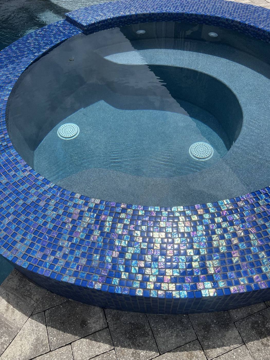 Finished spa with clean blue mosaic tile
