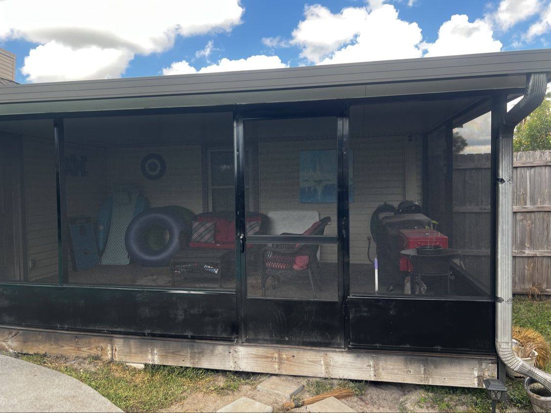After: the same patio enclosure fully rescreened with new black screens