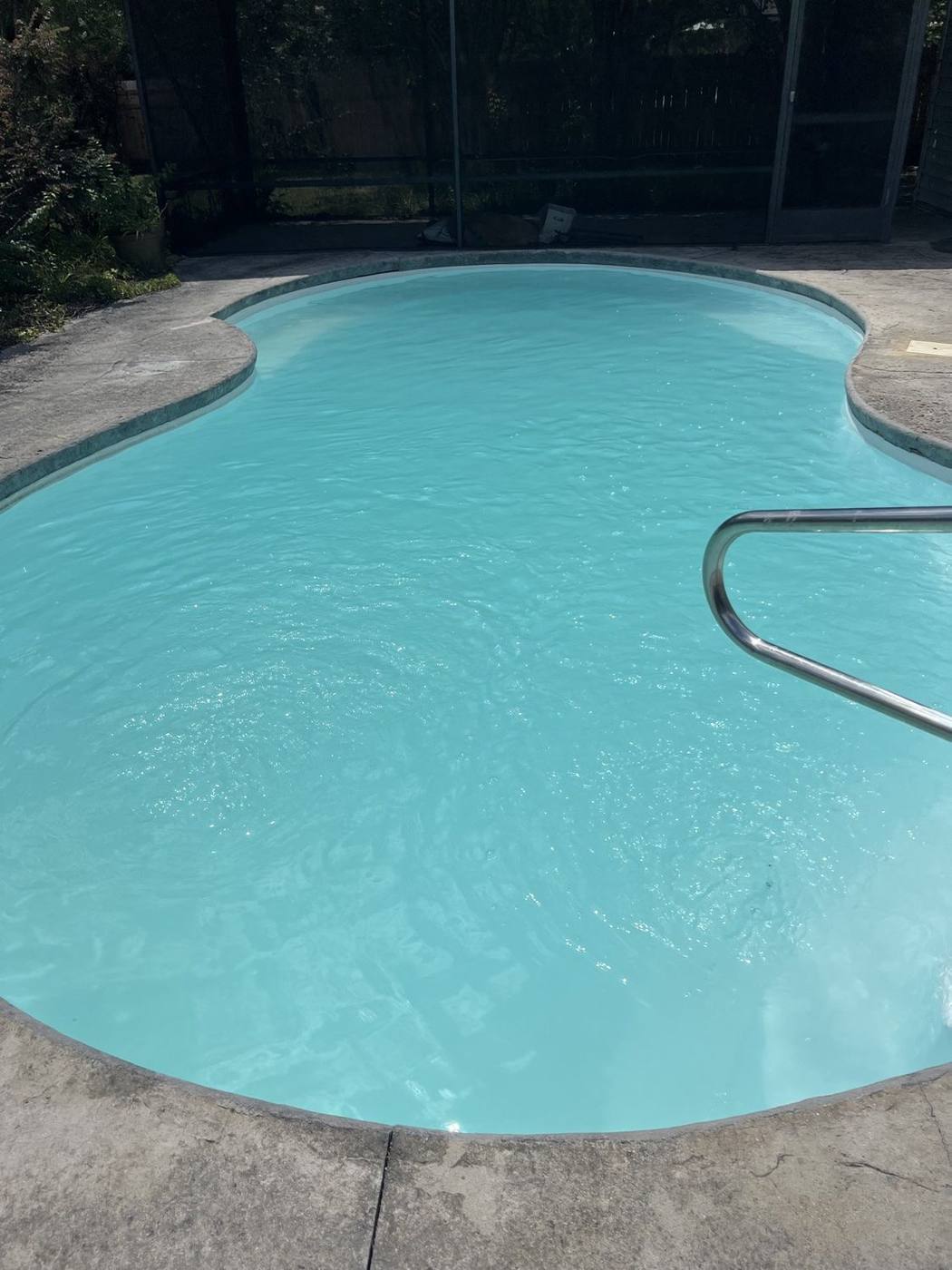 Same pool restored to clear blue water after algae removal
